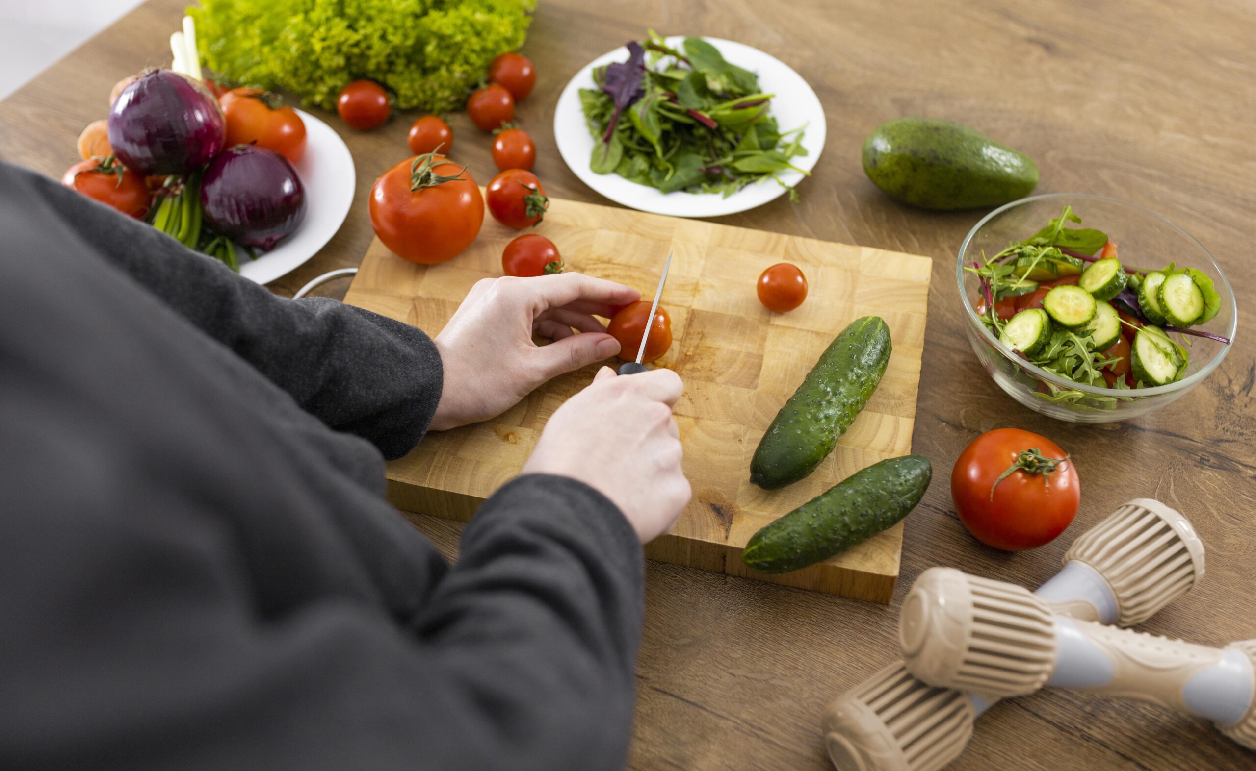 close up hand cutting tomato